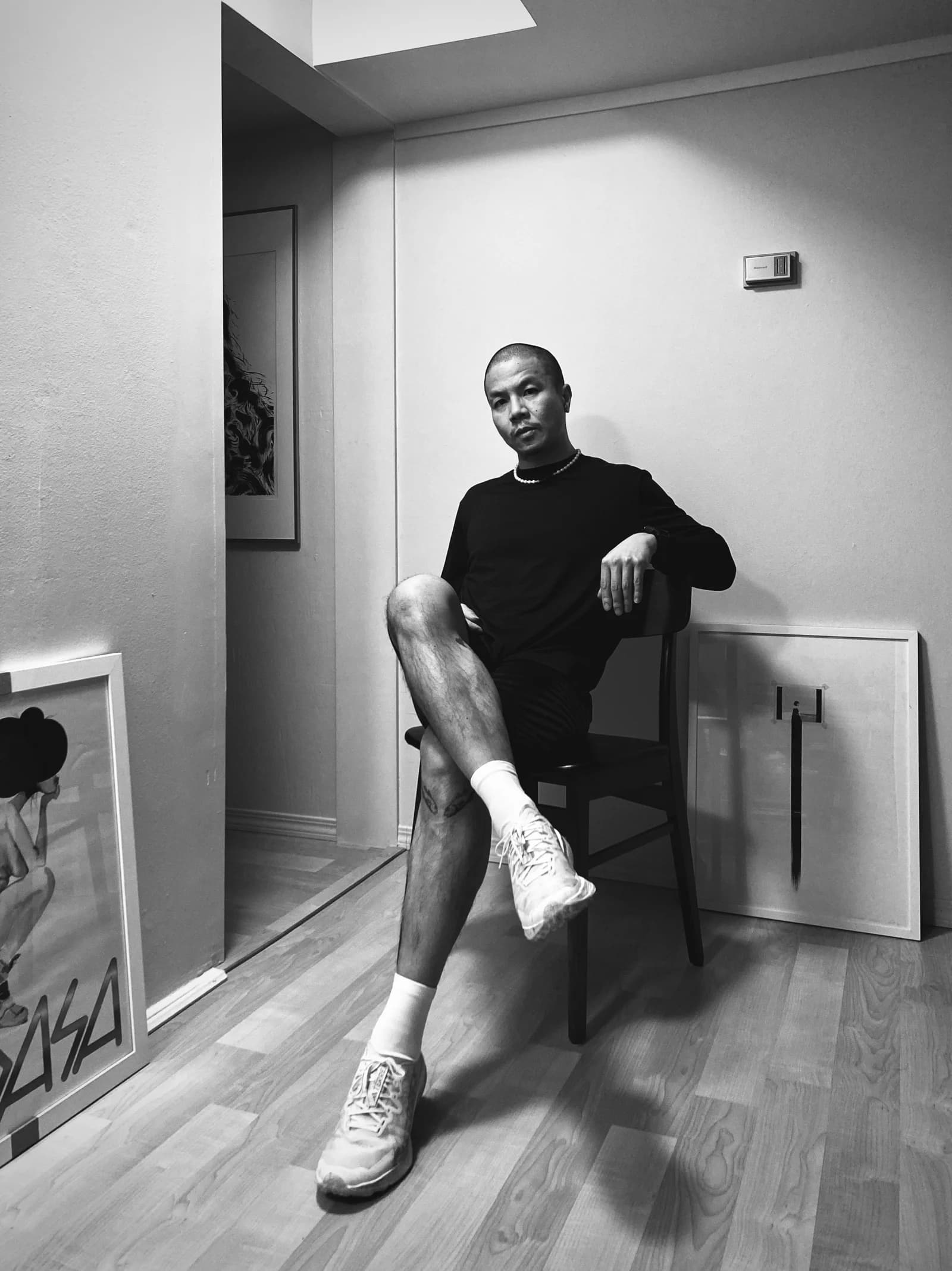 Artist Lynol Lui seated in his studio