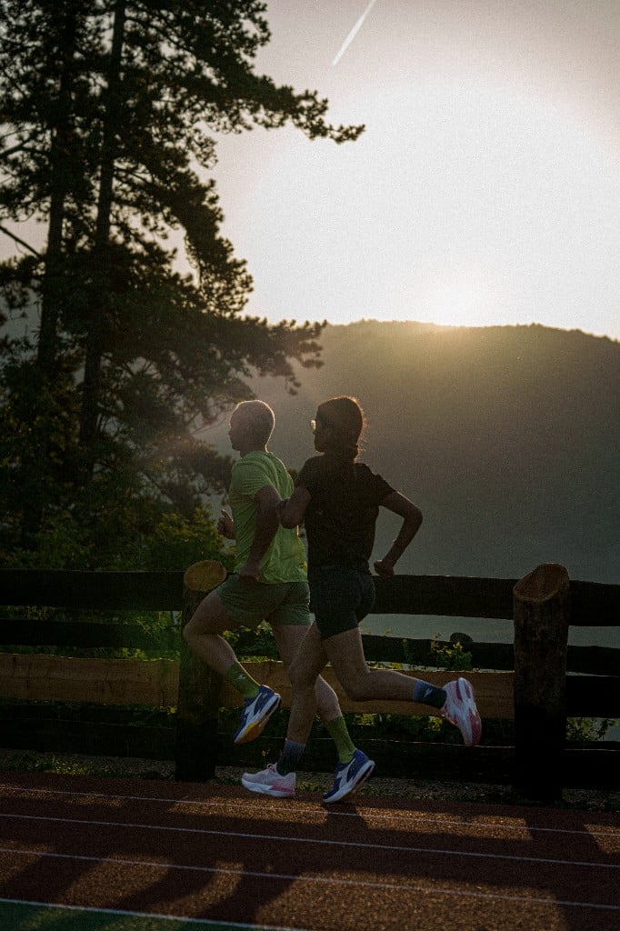 Diadora Own the Track lookbook — two runners on an outdoor track at golden hour in Vancouver